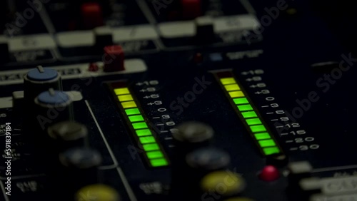 LED indicator level signal on the sound console.Volume level changes with green and yellow lights photo