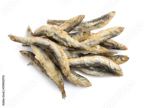 Pile of delicious fried anchovies on white background, top view