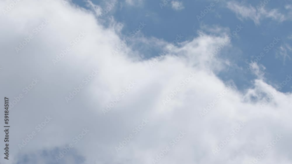 Time lapse of fluffy moving clouds on blue sky background Time lapse of fluffy moving clouds on blue sky background