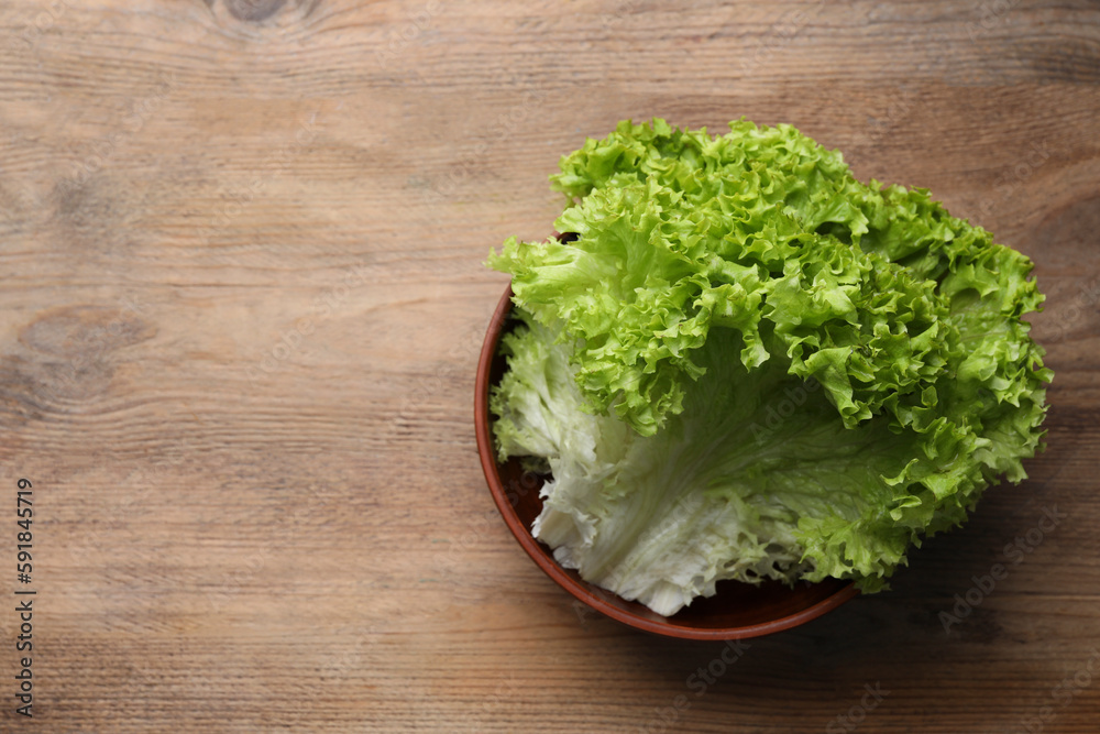 Fresh lettuce on wooden table, top view and space for text Fresh lettuce on wooden table, top view and space for text