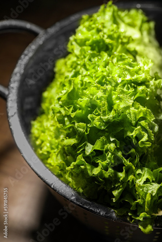Fresh lettuce on brown table, closeup. Salad greens photo