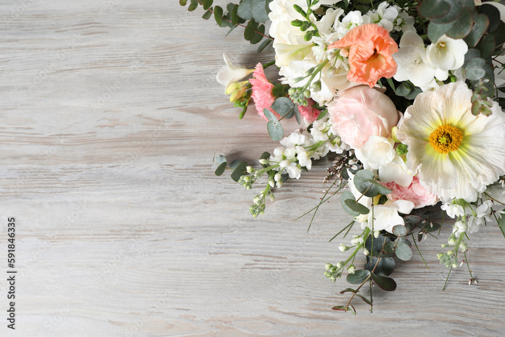 Bouquet of beautiful flowers on wooden table, space for text