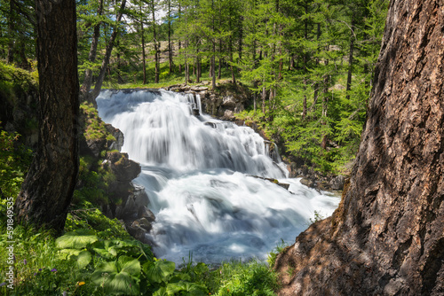 Waterfall in the Claree Valley in summer. Hautes Alpes (Fontcouverte in Cerces Massif), French Alps, France photo