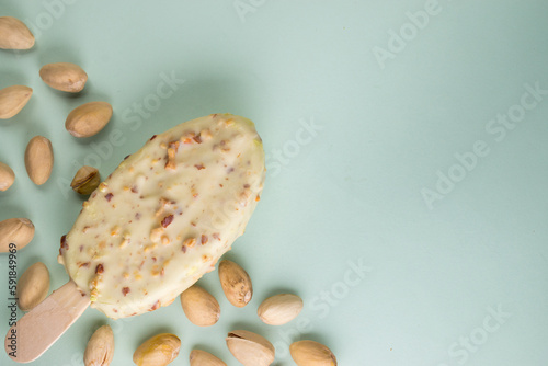 Fototapeta Top view of a white-glazed ice cream with pistachio with copyspace