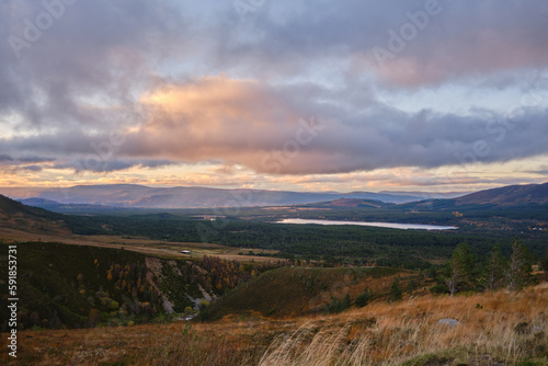 Beautiful view of a mountain river under overcast sky at sunset in Scotland