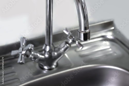 Chrome faucet without water and people.