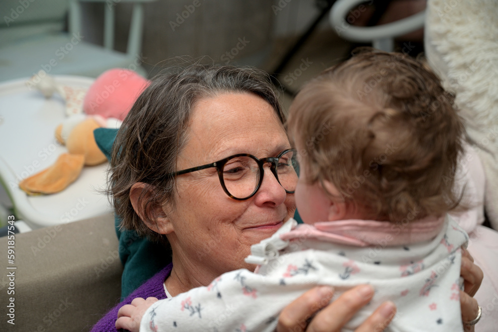 grandma and newborn baby playing together grandma and newborn baby playing together