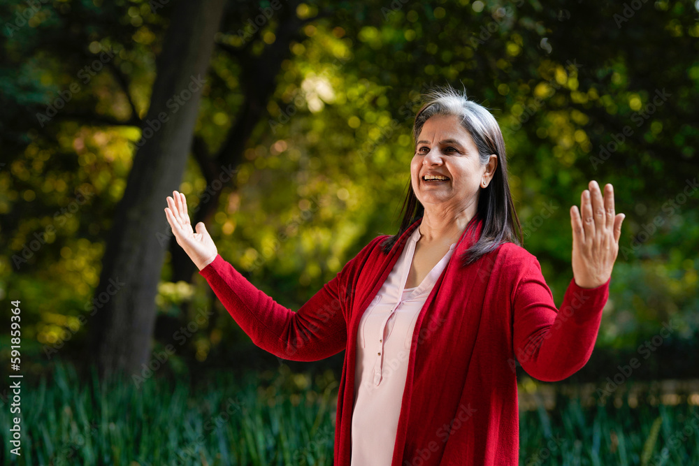 Indian old woman doing laughing yoga at park Indian old woman doing laughing yoga at park