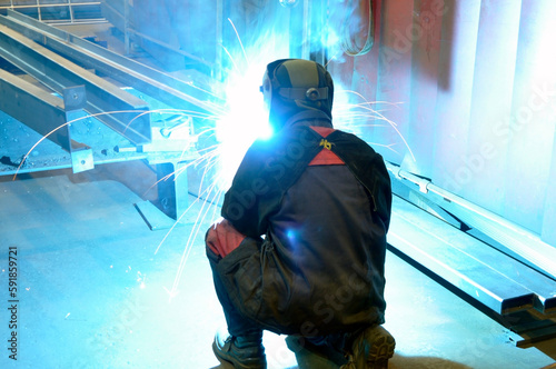 welding metal ideas in a forced position, kneeling.