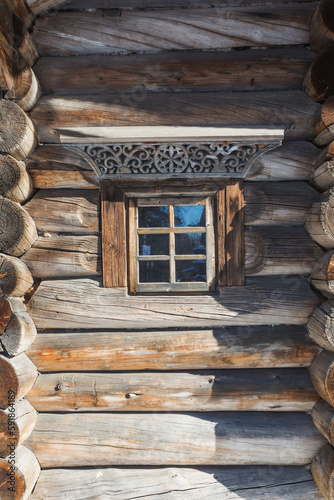 Window with carved architraves in Malye Korely, Arkhangelsk region, Russia photo