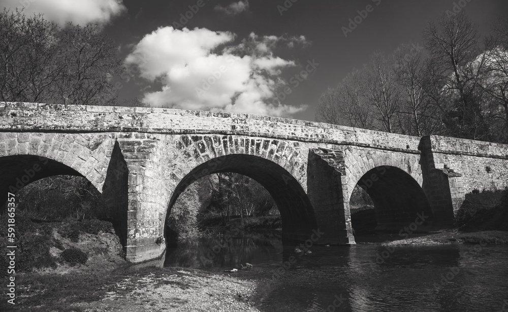 Roman bridge on old royal road from Paris to Sens over Yerres river near medieval town of Brie-Comte-Robert. Built in 17th-18th c. recalls architects name, Romains brothers. Black white historic photo