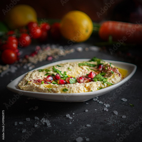 Delicious creamy hummus, close-up, garnished with olive oil, paprika, and parsley, traditional Middle Eastern dish