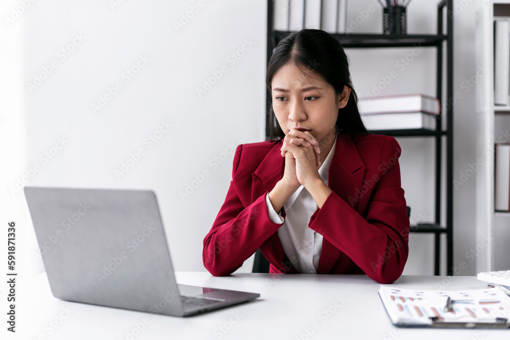 Businesswoman in suit feeling stressed while thoughtful about ac Businesswoman in suit feeling stressed while thoughtful about ac