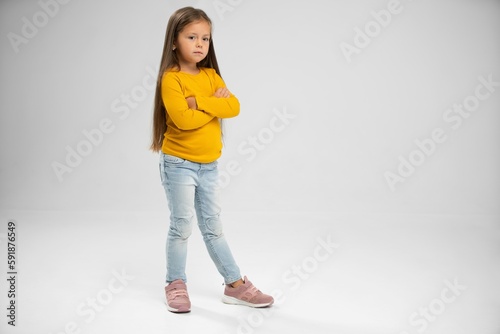 Full length of adorable six years old girl isolated on white studio background