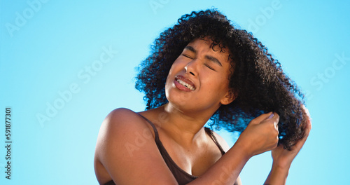 Afro, smile and black woman with comb for hair on blue background for wellness, cosmetics and health shine. Beauty salon, hairdresser and happy face of girl brushing for hairstyle, grooming and care