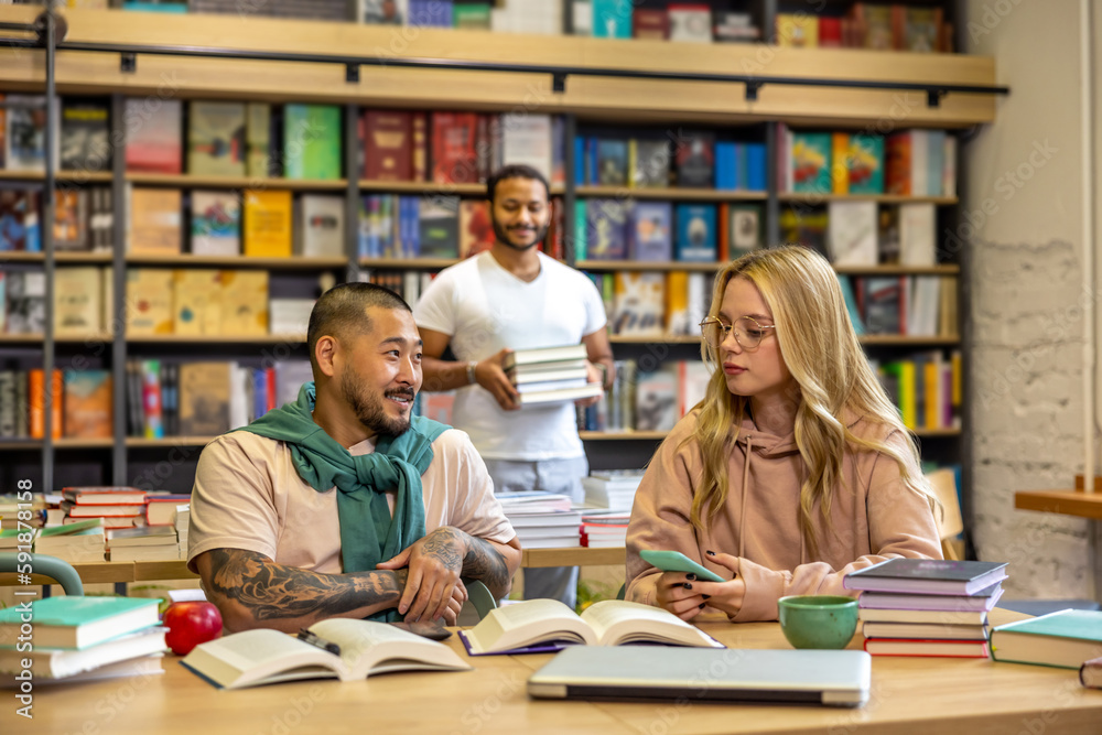 Group of people reading books in library Group of people reading books in library
