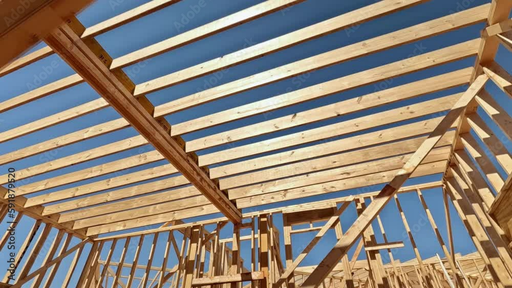 An enclosing beam supports framework of layout joists in newly constructed wooden structure. An enclosing beam supports framework of layout joists in newly constructed wooden structure.