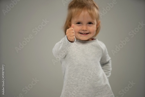 Portrait of a happy smiling child girl isolated over white background. Copy space for ad.