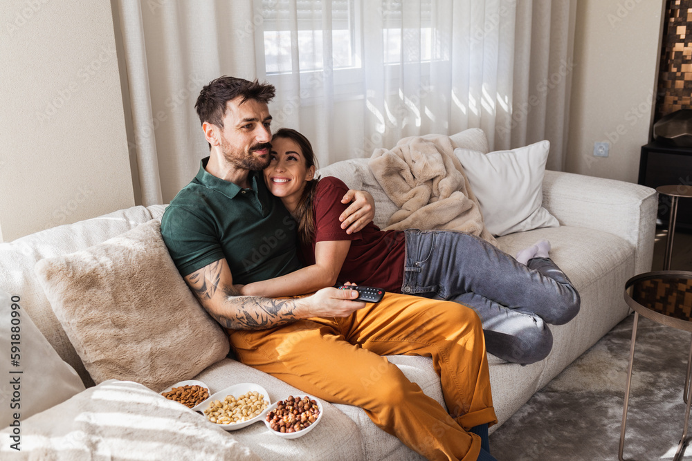 Young couple in love cuddling in their living room. Young couple in love cuddling in their living room.