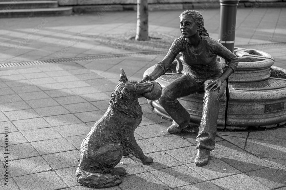 Grayscale shot of the Girl With Her Dog Statue Sculpture in Budapest