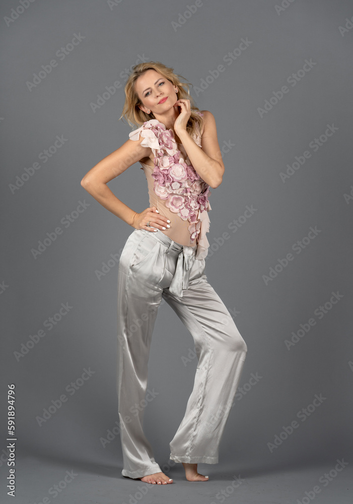 Beautiful Caucasian Blonde Woman Isolated on Gray Background. Colorful Suit. Happy Smiling Face Beautiful Caucasian Blonde Woman Isolated on Gray Background. Colorful Suit. Happy Smiling Face