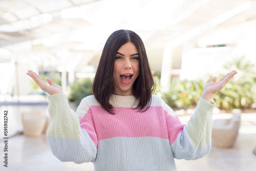 young pretty woman feeling happy, excited, surprised or shocked, smiling and astonished at something unbelievable young pretty woman feeling happy, excited, surprised or shocked, smiling and astonished at something unbelievable
