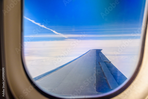 View on white clouds and wing from the airplane window