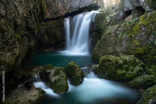 Waterfall with mossy rocks in forest  Svrakava waterfall near Banja Luka