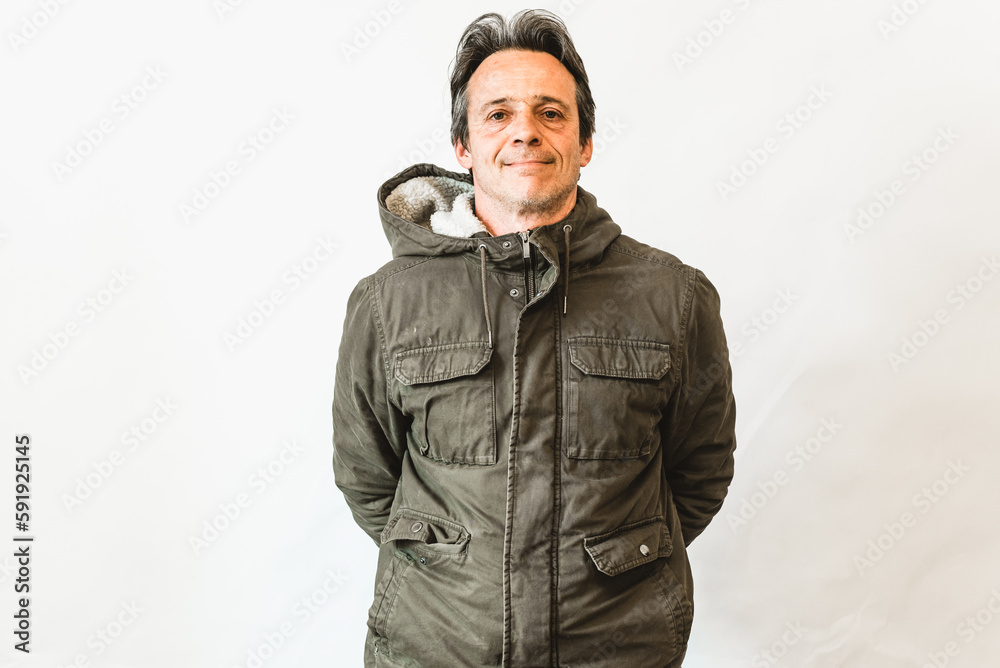 Happy laughing man, smiling middle aged old senior wearing green jacket standing arms crossed isolated on white wall, portrait Happy laughing man, smiling middle aged old senior wearing green jacket standing arms crossed isolated on white wall, portrait