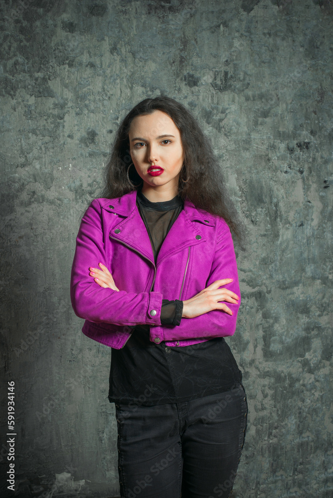 Beautiful sensual brunette in a jacket posing in the daylight from the window. Beautiful sensual brunette in a jacket posing in the daylight from the window.