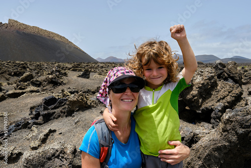 Mother and son taking a selfie while hiking between volcanoes. Lanzarote. Canary Islands
