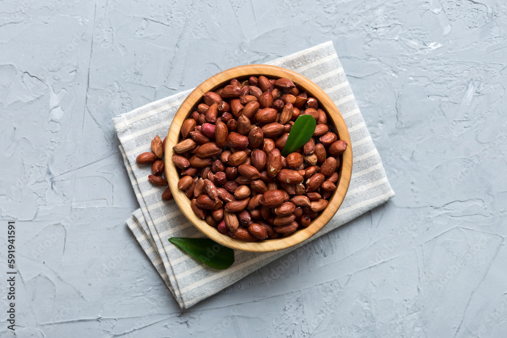 Fresh healthy peanuts in bowl on colored table background. Top view Healthy eating bertholletia concept. Super foods Fresh healthy peanuts in bowl on colored table background. Top view Healthy eating bertholletia concept. Super foods