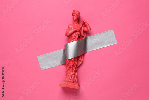Fototapeta Antique statue of venus fixed with adhesive tape on a pink background