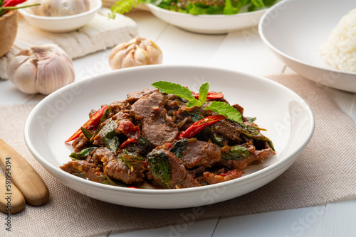Stir fried sliced Beef with Holy Basil in white plate.Thai famous food (Pad Kra pao)