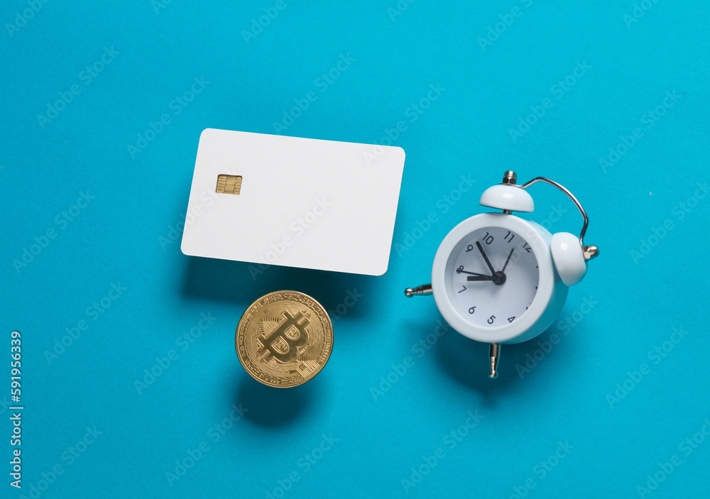 Mockup of white blank bank card with chip, bitcoin and alarm clock on blue background. Template for design. Top view Mockup of white blank bank card with chip, bitcoin and alarm clock on blue background. Template for design. Top view