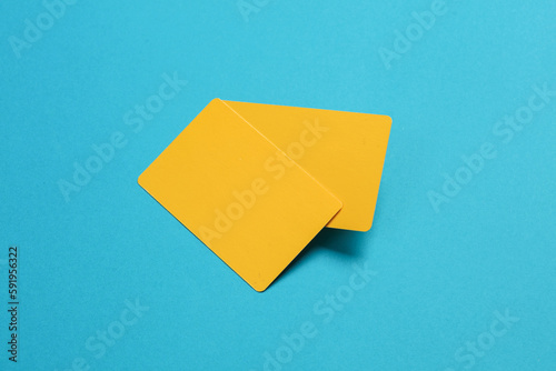 Stack of yellow empty bank cards on a blue background. Template for design