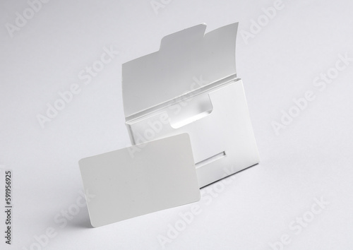 Packing box with empty white bank card on a gray background. Template for design