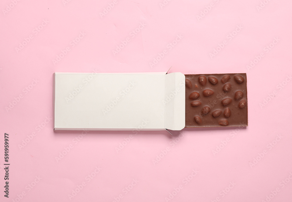 Mockup of white cardboard box with chocolate bar on pink background Mockup of white cardboard box with chocolate bar on pink background