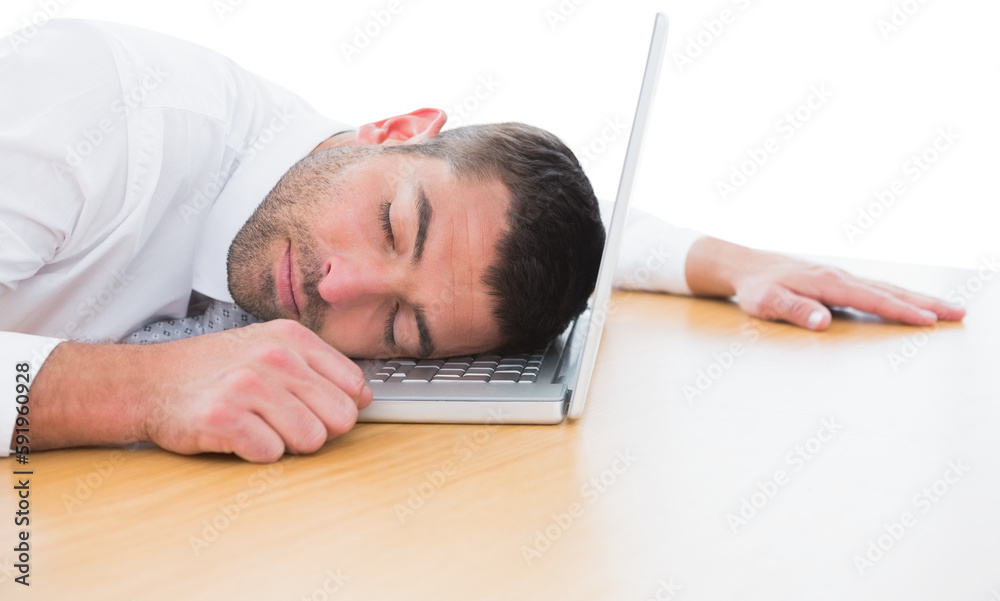 Businessman resting head on laptop