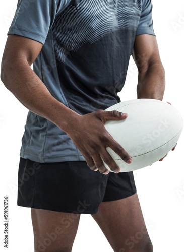 Mid section of athlete holding rugby ball