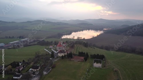 Picturesque aerial photography of rural land and lake in the evening. Top view drone shot. Agricultural area of czech republic, Europe. Spectacular photo wallpaper. Discover the beauty of earth.