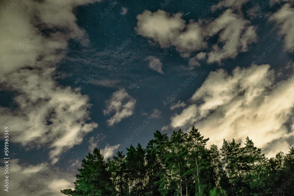 Atmospheric phenomenon of silvery clouds .night shining clouds. Beautiful sky. Blue silver clouds, or night shining clouds over the forest. a delightful landscape Atmospheric phenomenon of silvery clouds .night shining clouds. Beautiful sky. Blue silver clouds, or night shining clouds over the forest. a delightful landscape