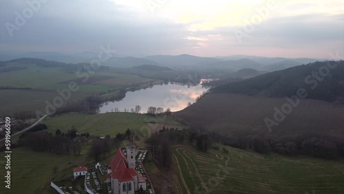 Picturesque aerial photography of rural land and lake in the evening. Top view drone shot. Agricultural area of czech republic, Europe. Spectacular photo wallpaper. Discover the beauty of earth.