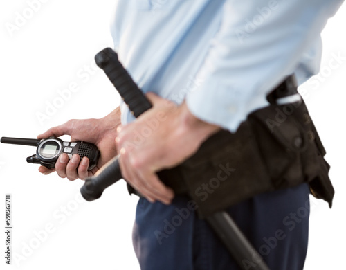 Mid section of security officer holding walkie talkie and baton