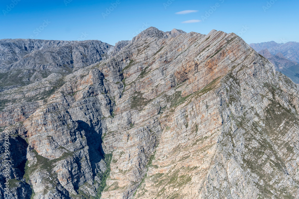 colorful rock layers of cliffs at Jan du Toit's  peak summit aerial, Worcester, South Africa