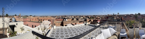 Morocco, Africa: panoramic view on a sunny day from a high rooftop, skyline of Marrakech, one of the four Imperial cities of Morocco situated west of the foothills of the Atlas Mountains   #591976149