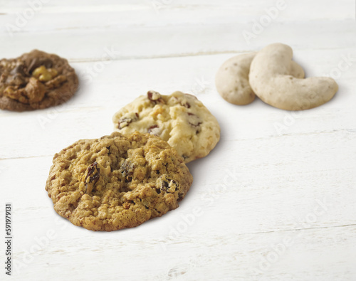 Variety of holiday cookies on a wooden white surface photo