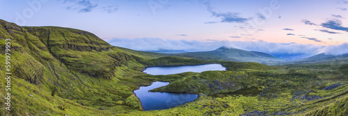 Panoramic view of two lakes in the Galty Mountains at dawn, panoramic stitched composite; County Limerick, Ireland photo