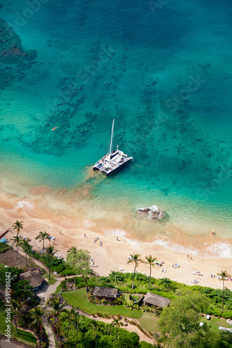 Aerial view of a catamaran moored along the shore at Maluaka Beach which fronts the Makena Beach Resort (formerly Maui Prince) under new development; Makena, Maui, Hawaii, United States of America photo
