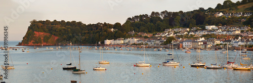 Boats moored in the harbor at twilight along the coastal seaside village of Shaldon at the mouth of the River Teign; Shaldon, Devon, England, Great Britain photo